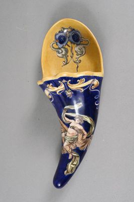 a picture of a blue and yellow spoon with a picture of a woman on it