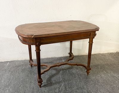 a small table with a wooden top on a cement floor