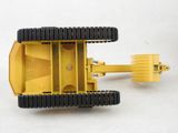 a close up of a yellow toy truck on a white surface