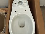 a box with a toilet and a bucket of water in it