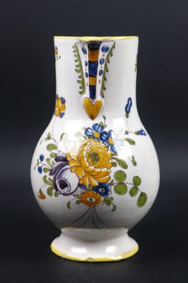 MOUSTIERS. Pichet en faïence à décor polychrome d'un bouquet…
