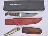 a knife, knife sharper, and sheath on a table