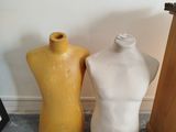 three mannequins sitting next to each other on the floor