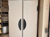 a white refrigerator in the corner of a room