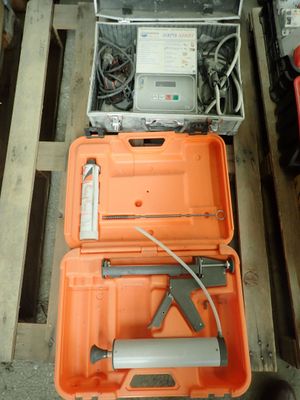 two orange cases with tools in them sitting on a pallet
