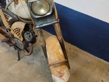 a old motorcycle with a helmet on it parked in a garage