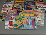 a lot of comic books sitting on a table