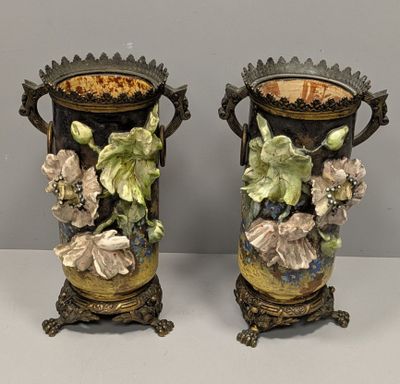 pair of antique vases with flowers and leaves painted on them