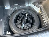 a tire in the trunk of a car with a wren in it