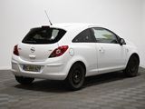 the back of a white car is parked in a room