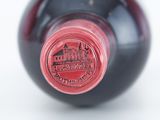 a close up of a wine bottle with a red label