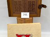 a small wooden easer with a book on top of it