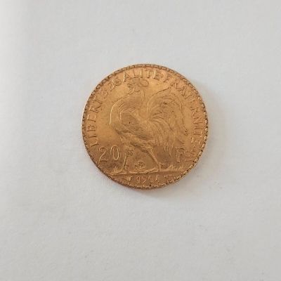 une image d'une pièce d'or sur une surface blanche