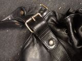 a black purse with a metal buckle on it