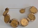 an image of a gold coin necklace and earrings on a white surface