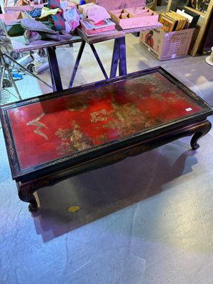 a coffee table with a red top in a room