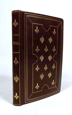 a brown book with gold decorations on the cover