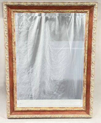 an ornate gold framed mirror with a white curtain behind it