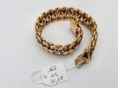 a gold chain bracelet with a tag attached to it