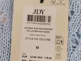 the label on the sweater is attached to the tag