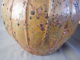 a brown vase sitting on top of a table