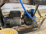 a machine that is sitting on the ground with a hose attached to it