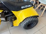 a small yellow and black motorcycle parked in a room