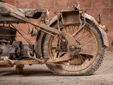 a old motorcycle parked in front of a brick wall