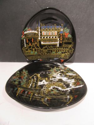 a black plate with a picture of a building on it