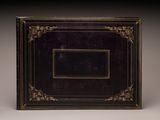 a black and gold photo album with a picture frame