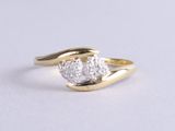 a close up of a diamond ring on a white surface