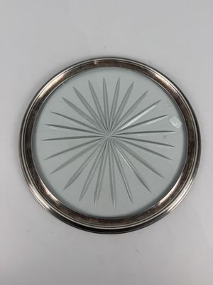 an image of a silver plate with a starburst design on it