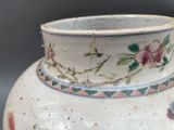 a white vase with a floral design on it