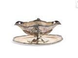 a silver plate with a silver saucer on it