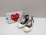 pair of black and white converses with a red heart on the side