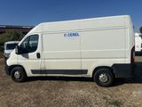 a white van parked in a lot with other vehicles in the background