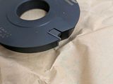 a black object that is sitting on a piece of paper