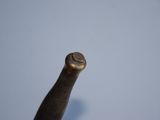 a baseball bat that is in the air with a ball in the background