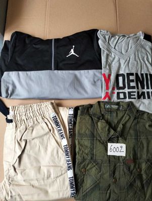three pairs of men ' s clothing laid out on a cardboard box