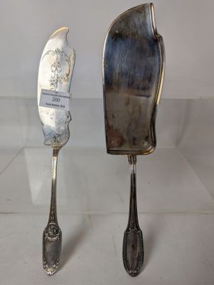 two spoons and a knife on display on a table