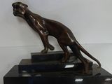 a bronze statue of a dog on a pedestal