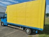 a blue and yellow truck that is parked in a parking lot