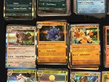 a lot of different pokemon cards on the table