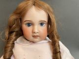 a close up of a doll with long hair