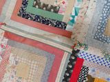 a close up of a patchwork quilt on a table