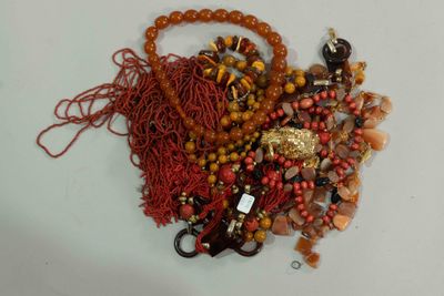 a pile of assorted beads on a white surface