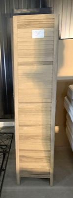 a stack of towels sitting on a shelf in a room