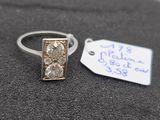 a silver ring with two diamonds on it and a price tag