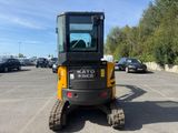 a picture of a small construction vehicle parked in a parking lot