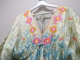 an image of a woman ' s blouse hanging on a hanger